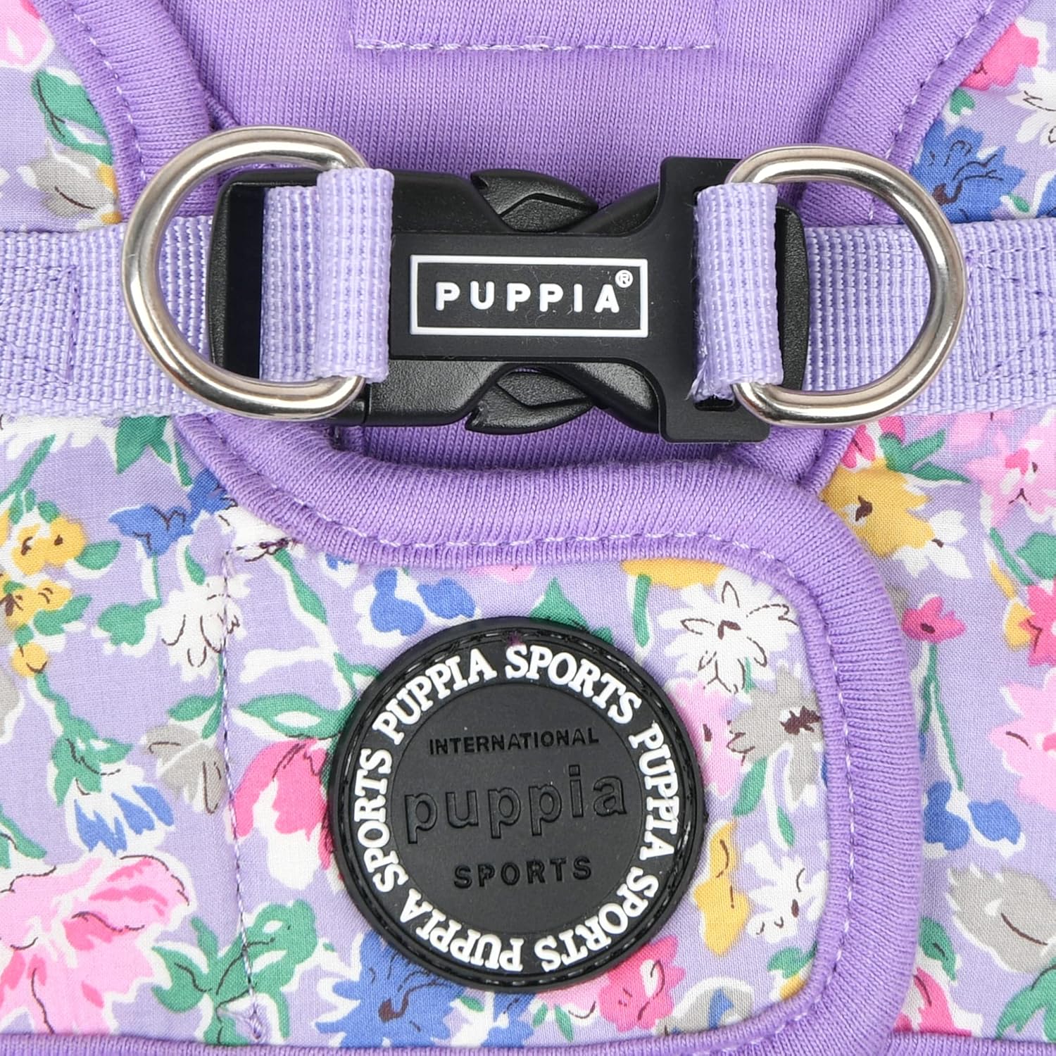 Purple floral dog harness with Puppia branding on a floral background