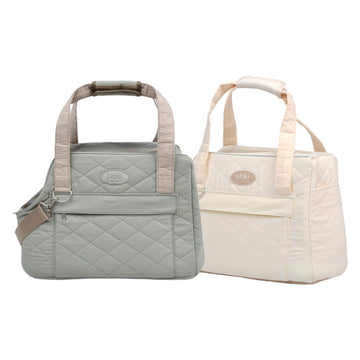 Two quilted pet carrier handbags, one gray and one beige
