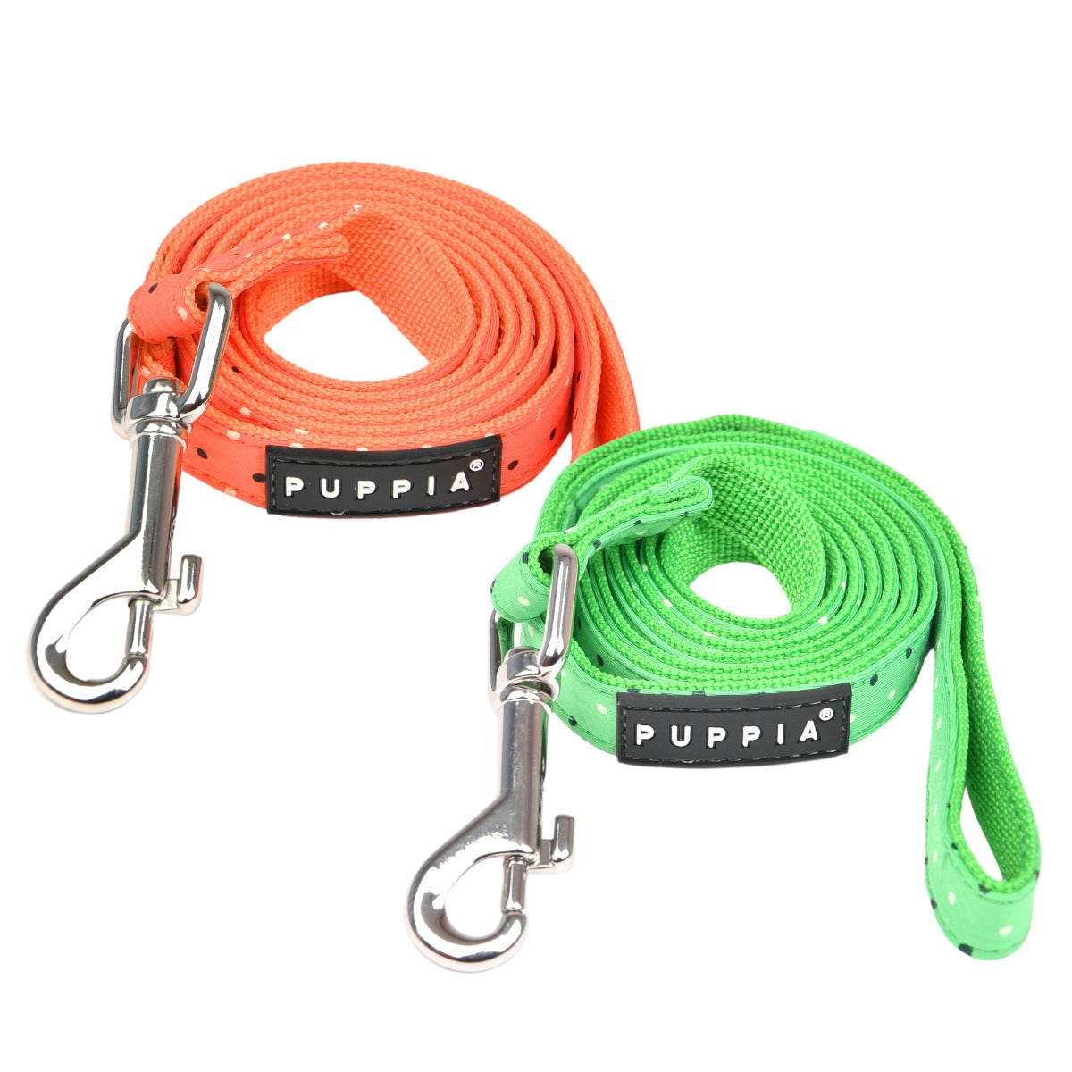 Two dog leashes, one orange and one green, with metal hooks on a white background. Brand 'Puppia' visible.