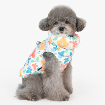 Small dog wearing a colorful floral-patterned winter sleeveless puppia coat
