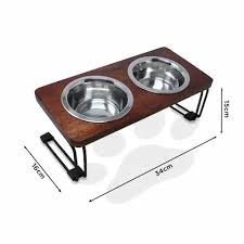 Pet feeding station with two bowls on a wooden stand, dimensions displayed.