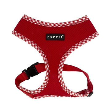 Red dog harness with checkered trim and Puppia logo on a white background